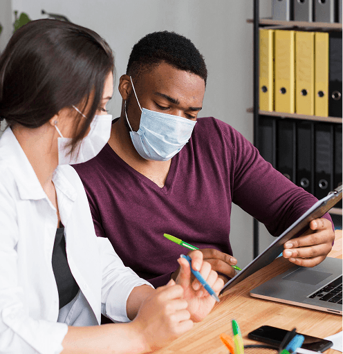 Two care professionals reviewing a care management system together
