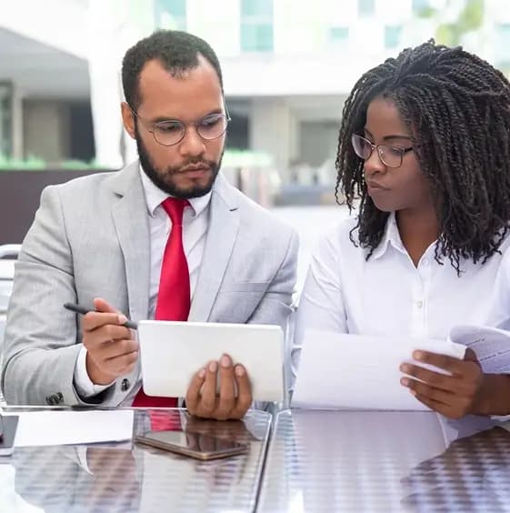 Professionals reviewing documents for a Welsh domiciliary care agency business plan