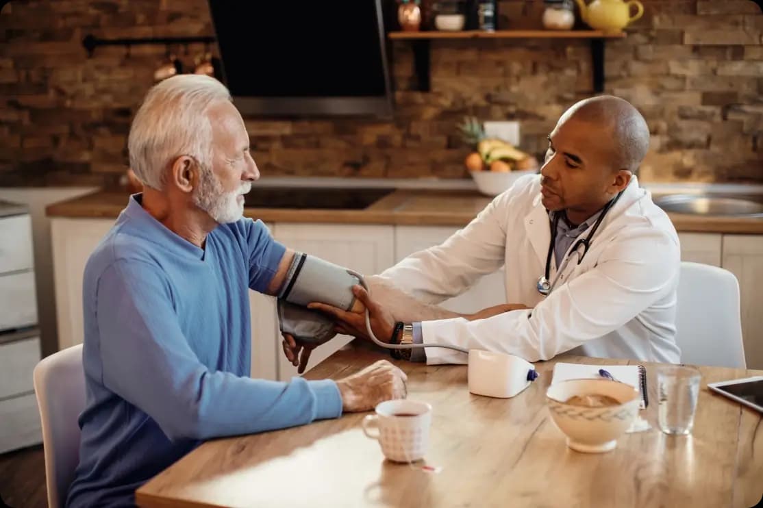 Doctor measuring a senior man's blood pressure
