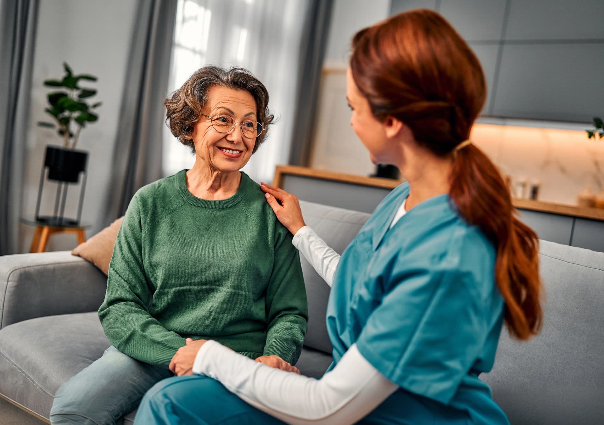 Nurse speaking with a senior woman during quality monitoring