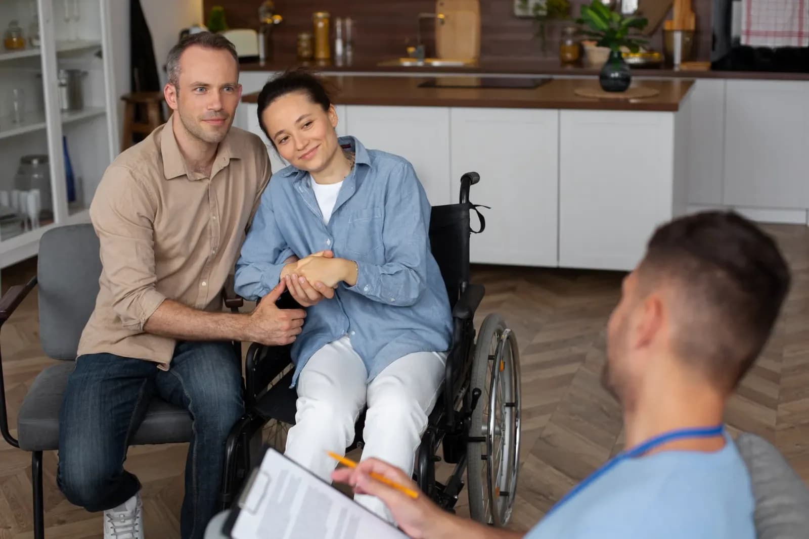 A support worker going through a care plan with a woman and her partner at home