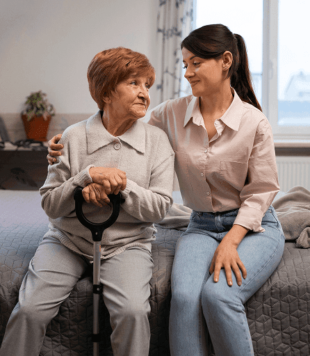 A carer supporting an older woman at home