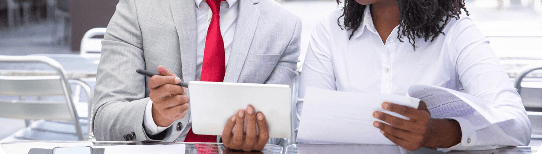 Two care business professionals reviewing marketing materials