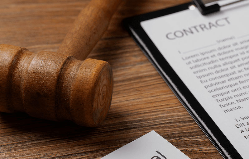 A gavel resting beside a contract document