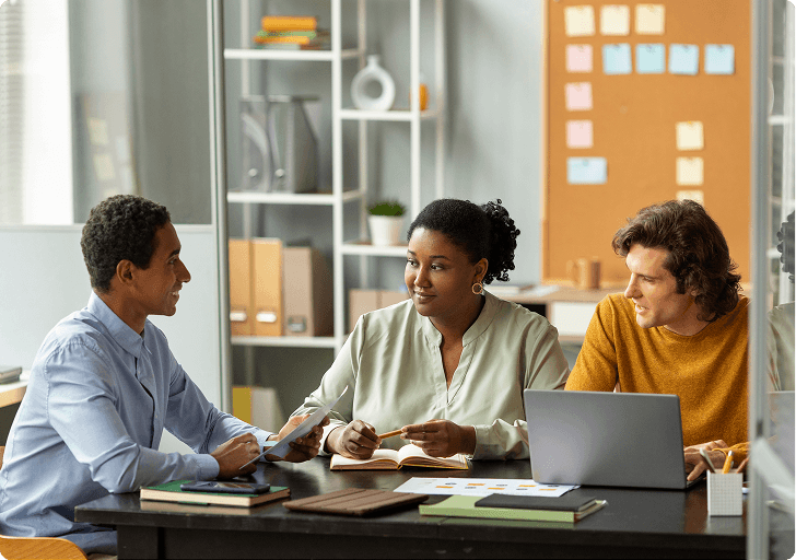 A team of care professionals meeting at a desk
