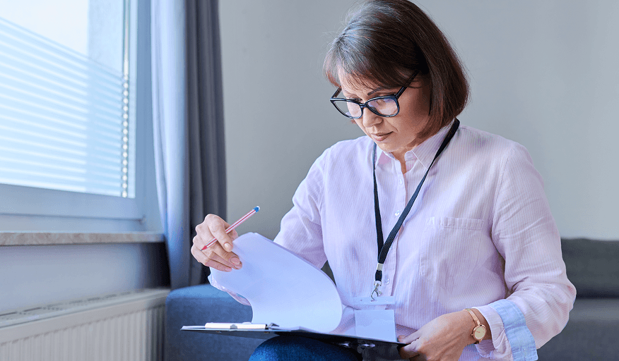 A care professional reviewing procurement documents