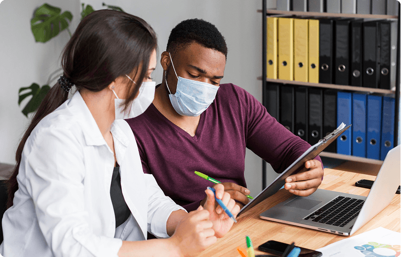 Two care professionals reviewing a contract at a desk
