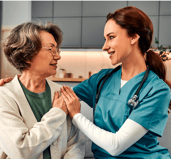 A care worker supporting an older woman at home