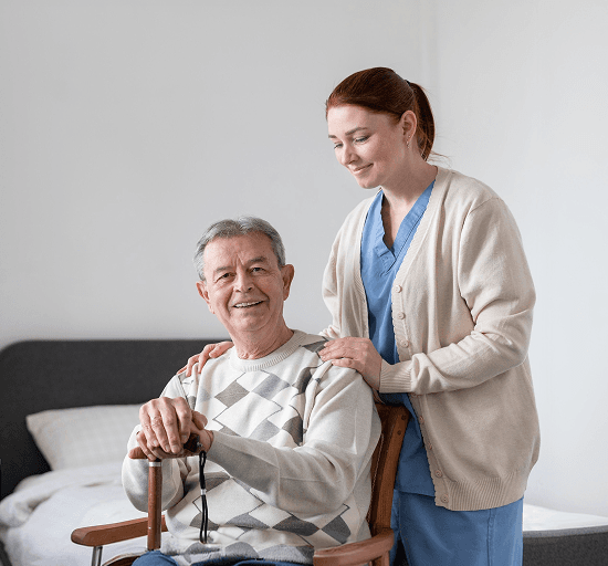 A care worker supporting an older man in supported living accommodation