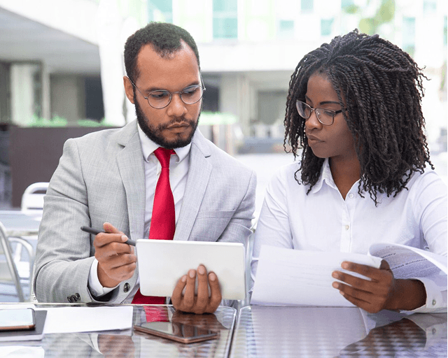 A nominated individual reviewing oversight reports with the registered manager