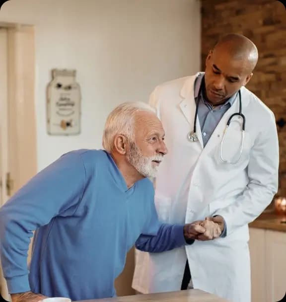 Doctor helping an older man at home
