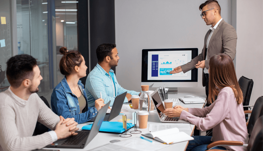 A team reviewing RQIA compliance reporting in Care Sync Pro