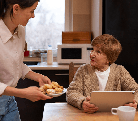 Care worker supporting an extra care resident in her own flat