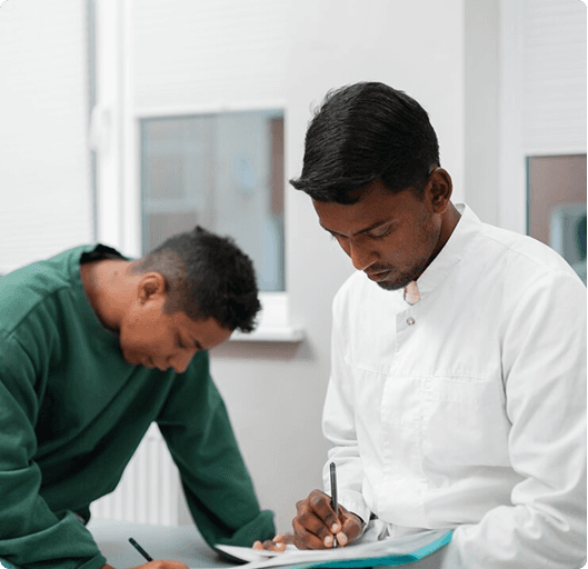 Two care professionals completing reablement paperwork together