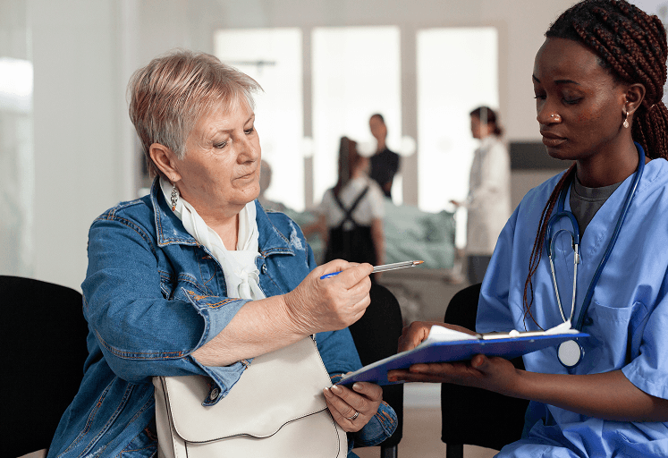 A discharge nurse discussing a reablement referral with a service user