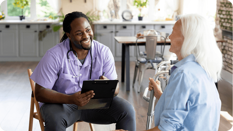 Care professional talking with an elderly resident at home